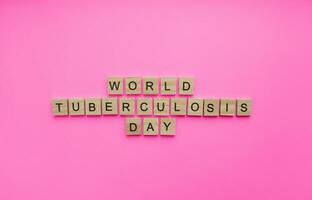 On March 24, World Tuberculosis Day, a minimalistic banner with an inscription in wooden letters photo