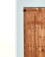 Vintage wooden door on a blue wall, minimalistic architectural detail. photo