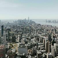 Aerial view of a dense urban New york cityscape with skyscrapers under a clear sky. photo