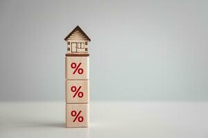 Home interest rate finance and mortgage rates. Refinance to reduce the interest of home loan. Percentage sign and house model on top. Repayments, credit limit, inflation, sale price and tax rise. photo