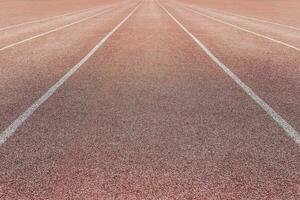 Sports surface, stadium running track. Background for motivation, striving forward. Copyspace photo