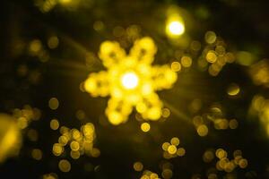 Abstract background with Christmas or New Year festive sparkling light in the form of defocused bokeh photo