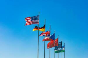 National flags on flagpoles of various states photo