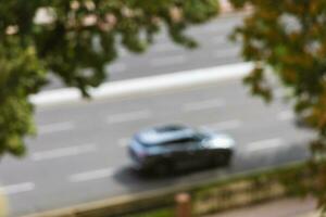 A car on the road in motion in a blurry photo. photo