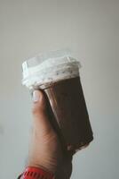 Iced mocha with milk or cream in hand photo