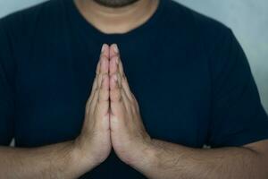 Asian man to pay respect with hands, symbol of Thailand photo