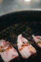 Raw beef slice for barbecue over charcoal on stove in restaurant, Japanese food photo