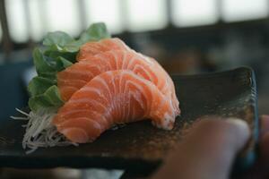 rebanada de salmón crudo o sashimi de salmón al estilo japonés fresco foto