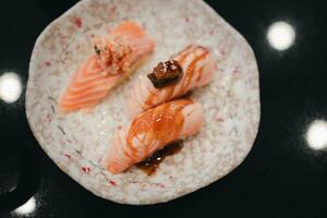 Set of raw salmon sushi with various topping photo