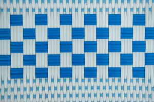 Texture of white and blue synthetic fabric. Perpendicularly woven white and blue plastic threads. photo