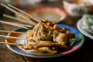 cerca arriba de A la parrilla Cerdo satay en platos foto