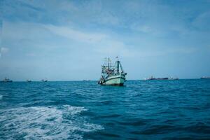 Old wooden fishing boat trawler on sea at Samaesarn Island Chonburi Thailand. photo