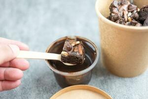 Delicious chocolate brownie doing dipping melted chocolate photo