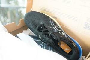 Bangkok, Thailand - January 7, 2024 New shoes with ASICS Running Shoes Gel Nimbus 25 WIDE. photo