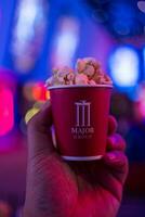 Bangkok, Thailand - December 29, 2023 A mini cup of popcorn for tester new popcorn taste from Major Cineplex Thailandd photo