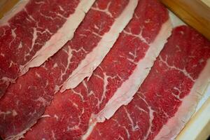 Fresh beef raw sliced with marbled texture photo