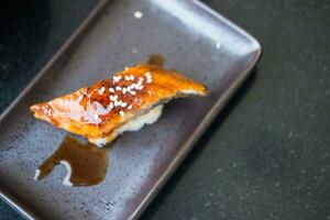 Eel fish grilled on rice moisten with sweet sauce and white sesame. Japanese food photo