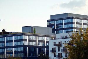 Glass building with transparent facade of the building and blue sky. Structural glass wall reflecting blue sky. photo