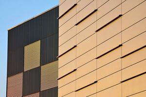 Abstract closeup of the glass-clad facade of a modern building covered in reflective plate glass. Architecture abstract background. Glass wall and facade detail. photo