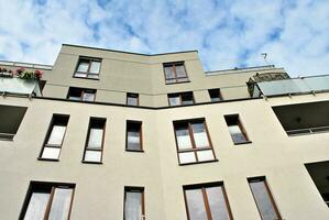 Modern luxury residential flat. Modern apartment building on a sunny day. White apartment building with a blue sky. Facade of a modern apartment building. photo