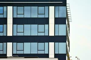 Glass building with transparent facade of the building and blue sky. Structural glass wall reflecting blue sky. photo