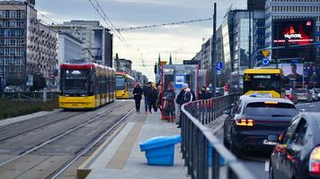 Warsaw, Poland. 29 December 2023. Street photography. People on the city street in the winter day. Passengers on the tram stop. Lifestyle of the city photo