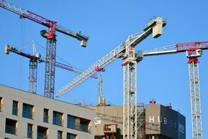 High rise building under construction. Installation of glass facade panels on a reinforced concrete structure. photo