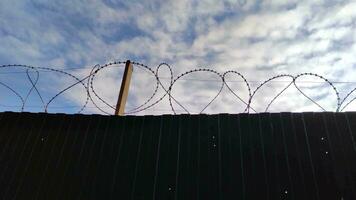 Prison fence with metal barbed wire 4K video footage