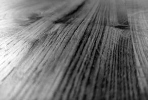 Natural wood black and white background with blurred elements. Monochrome wooden surface pattern, grayscale wood texture photo