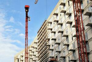 alto subir edificio debajo construcción. instalación de vaso fachada paneles en un reforzado hormigón estructura. foto