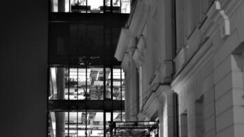 Pattern of office buildings windows illuminated at night. Glass architecture ,corporate building at night - business concept. Black and white. photo