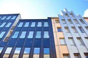 Abstract closeup of the glass-clad facade of a modern building covered in reflective plate glass. Architecture abstract background. Glass wall and facade detail. photo