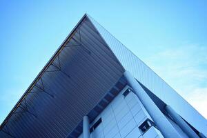 Abstract closeup of the glass-clad facade of a modern building covered in reflective plate glass. Architecture abstract background. Glass wall and facade detail. photo