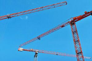 High rise building under construction. Installation of glass facade panels on a reinforced concrete structure. photo