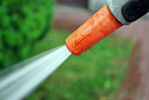 Water spraying from a garden hose photo