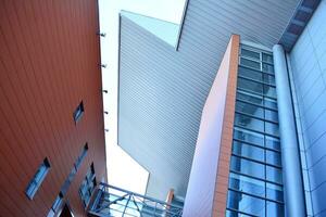 Abstract closeup of the glass-clad facade of a modern building covered in reflective plate glass. Architecture abstract background. Glass wall and facade detail. photo