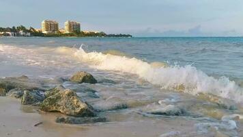 Stones rocks corals turquoise green blue water on beach Mexico. video