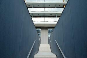 Abstract closeup of the glass-clad facade of a modern building covered in reflective plate glass. Architecture abstract background. Glass wall and facade detail. photo