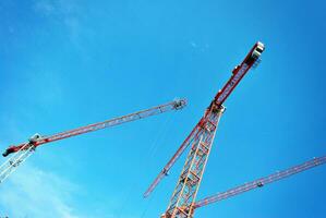 High rise building under construction. Installation of glass facade panels on a reinforced concrete structure. photo