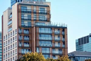 Modern and new apartment building. Multistoried, modern, new and stylish living block of flats. photo