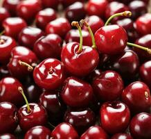 AI generated Fresh cherries on a wooden table. Top view. Copy space. photo