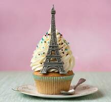 AI generated Eiffel tower cupcake with white buttercream frosting, selective focus photo