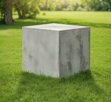 AI generated White concrete cube on green grass in the park with copy space. photo