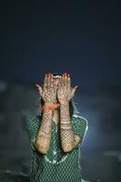 A Beautiful artwork henna on the hand of an Indian bride with herbal heena in wet condition photo