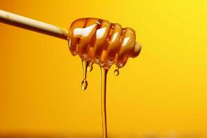 AI generated Honey elegance golden drops fall from a spoon, yellow backdrop photo