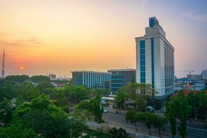 Indonesian morning view in the city of Jakarta during a beautiful morning with sunrise and tall buildings photo