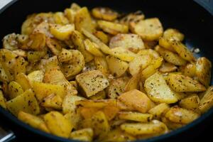 roasted potatoes with bacon onions and spices photo