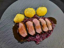 roasted duck with red  cabbage and potatoes photo