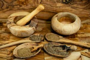 caraway seeds Carum carvi on olive wood photo