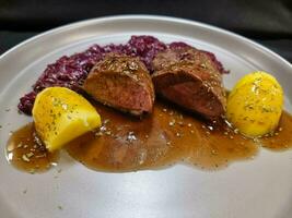 roasted duck with red  cabbage and potatoes photo